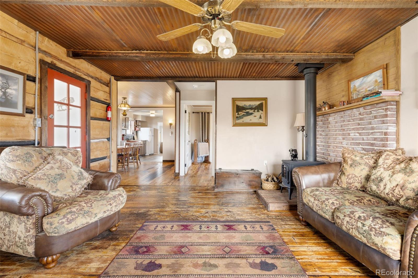 154 Mariposa Street Hartsel, CO 80449 - Photo 10 of 48 a living room with furniture and a chandelier
