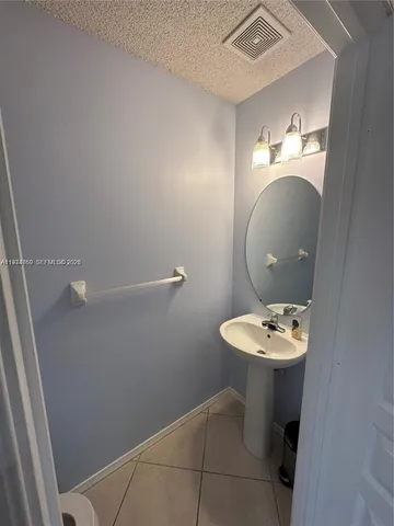 a bathroom with a sink mirror and toilet