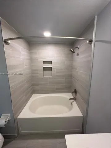 a bathroom with a bathtub and shower