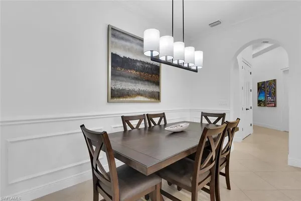 a dining room with furniture and chandelier