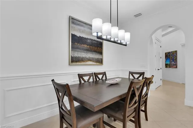 a dining room with furniture and chandelier