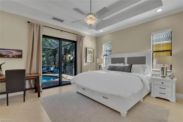 a spacious bedroom with a bed and a chandelier