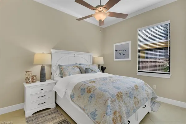 a large bed sitting in a bedroom next to a window