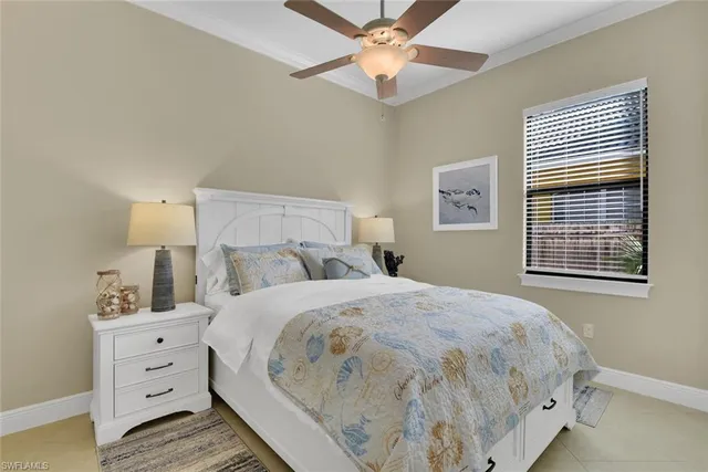 a large bed sitting in a bedroom next to a window