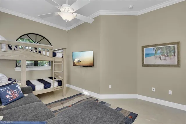 a living room with furniture and a ceiling fan