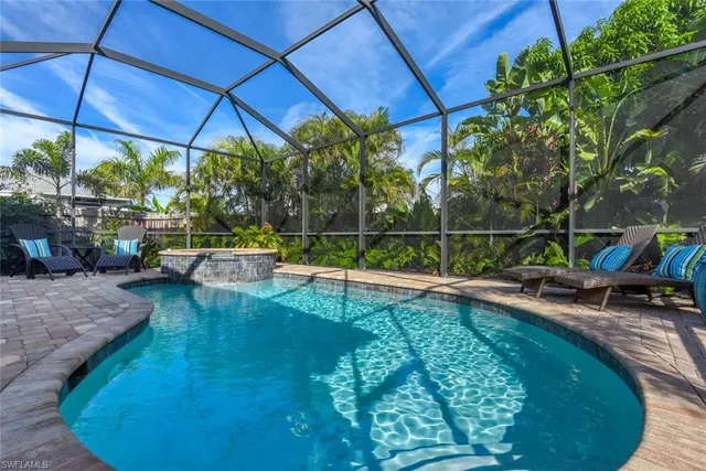 a view of a swimming pool with a patio and a yard