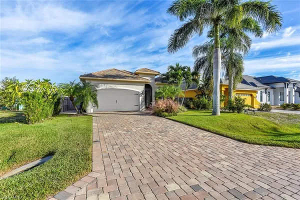 a front view of a house with a garden and a yard