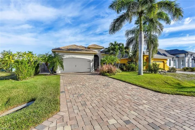 a front view of a house with a garden and a yard