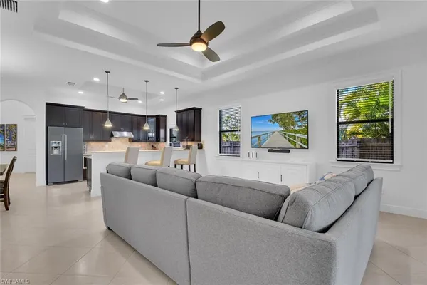 a living room with furniture and kitchen view
