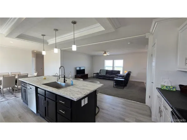 a kitchen with a sink counter and chairs