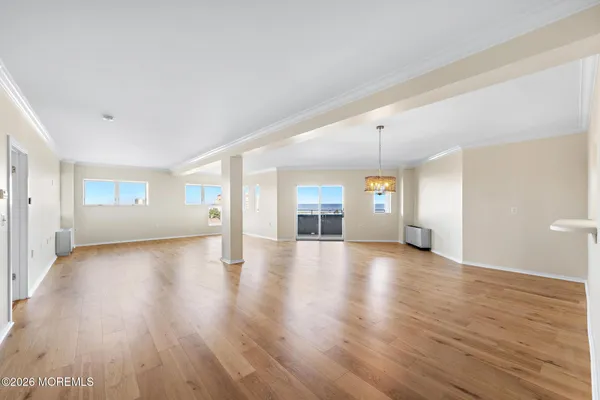 a view of a livingroom with wooden floor and staircase