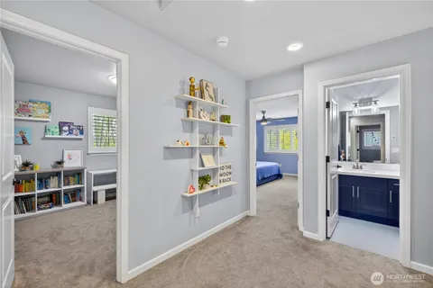 a living room with furniture and a book shelf