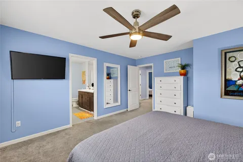 a bedroom with furniture and a flat screen tv