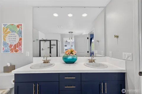 a bathroom with a sink double vanity and a mirror
