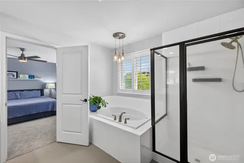 a bathroom with a tub sink and mirror