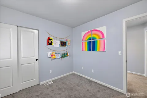 a room with window and refrigerator