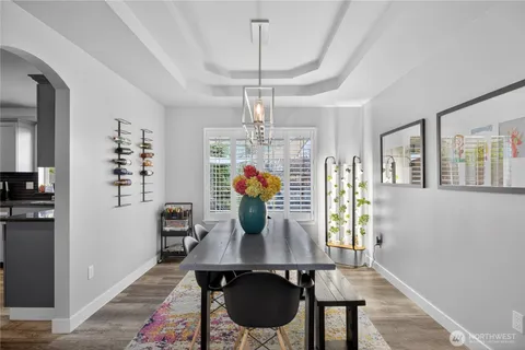 a view of a dining room with furniture wooden floor and chandelier