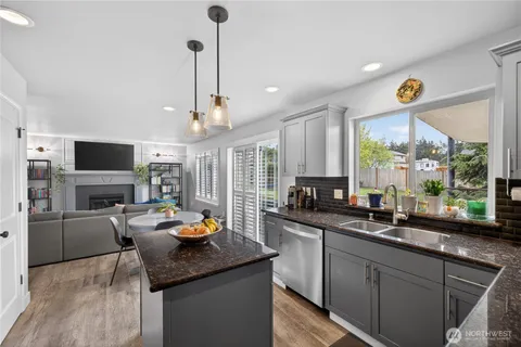 a kitchen with stainless steel appliances granite countertop a sink counter space cabinets and a window