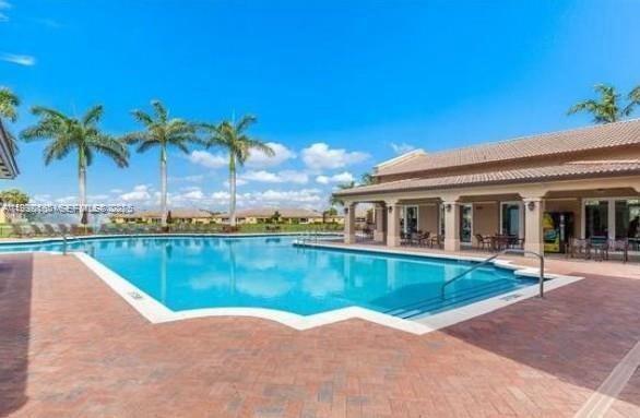 1398 Northeast 33rd Avenue, Unit 10825 Homestead, FL 33033 - Photo 8 of 8 a view of a house with swimming pool and a yard