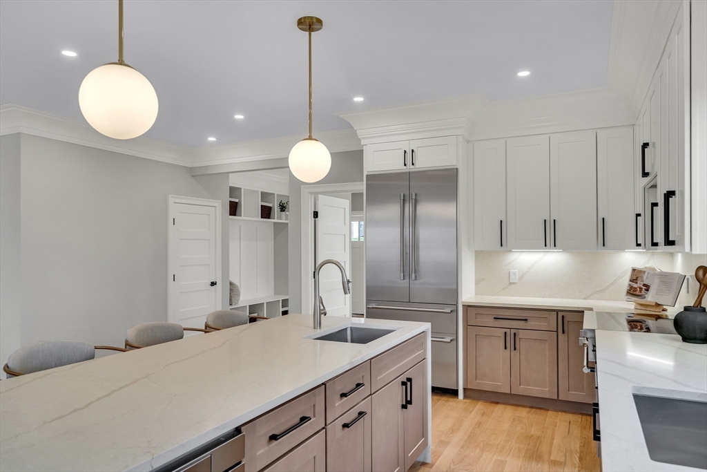 24 Deering Avenue Lexington, MA 02421 - Photo 11 of 42 a kitchen with kitchen island a sink stainless steel appliances and cabinets