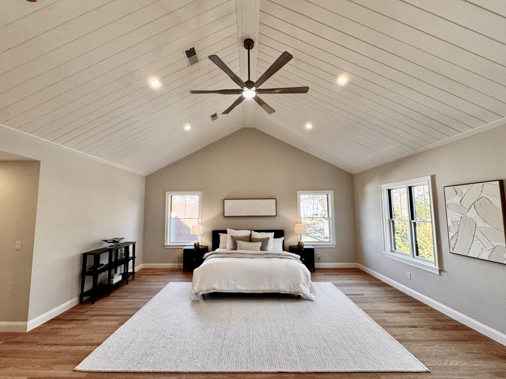 24 Deering Avenue Lexington, MA 02421 - Photo 18 of 42 a bedroom with a large bed and a chandelier