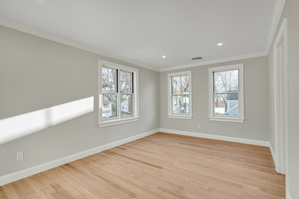 24 Deering Avenue Lexington, MA 02421 - Photo 31 of 42 a view of an empty room with wooden floor and a window