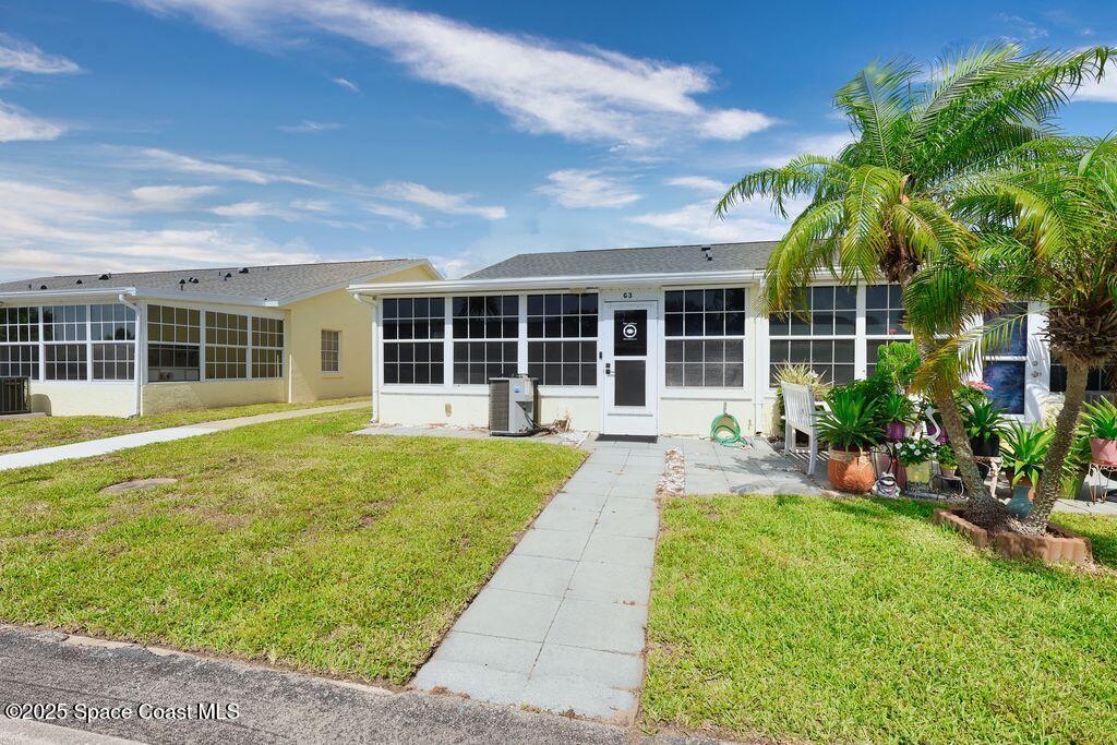 8520 U.S. Rte 1, Unit G3 Micco, FL 32976 - Photo 2 of 12 a view of a house with a yard and potted plants