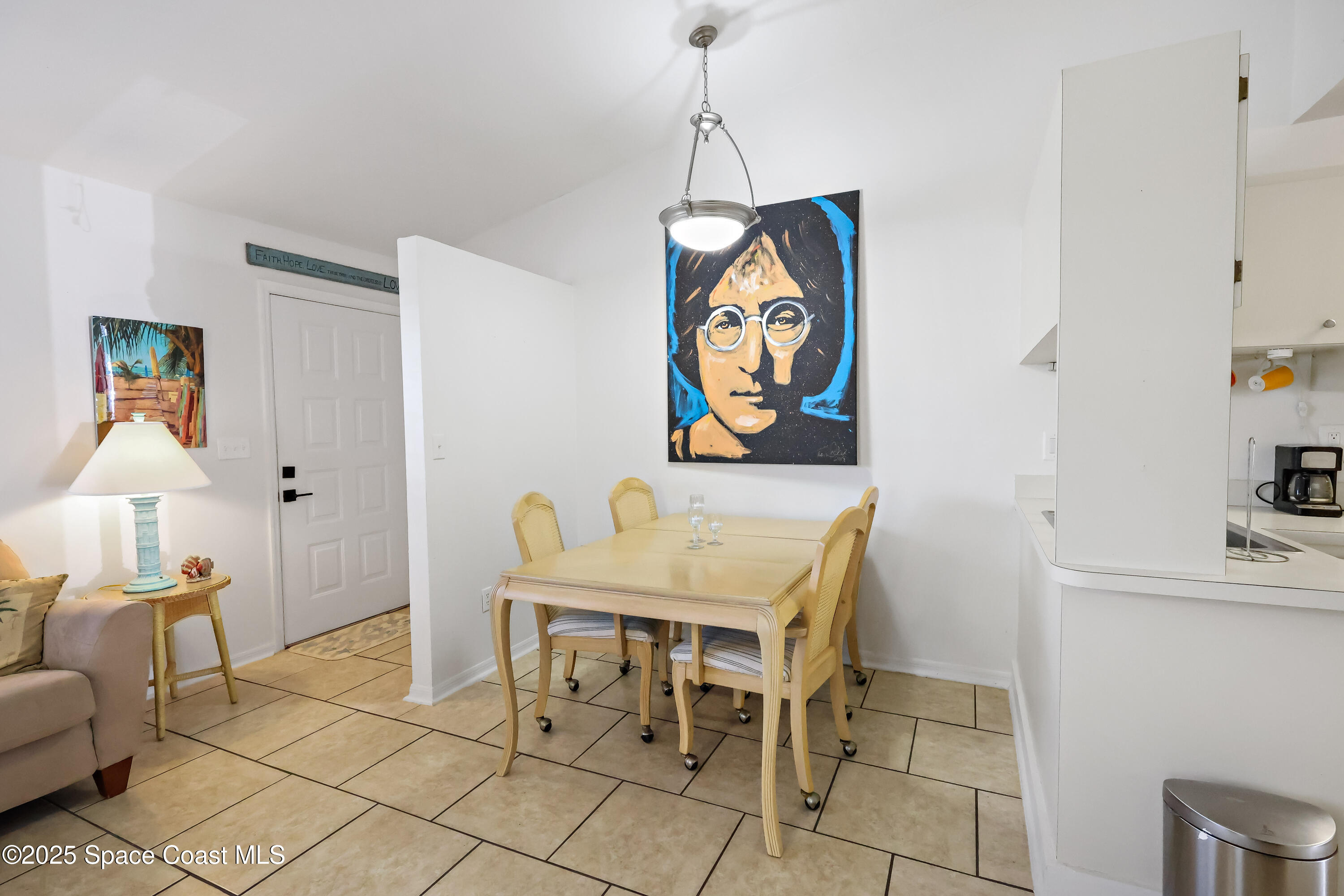 8520 U.S. Rte 1, Unit G3 Micco, FL 32976 - Photo 3 of 12 a view of a dining room with furniture and wooden floor