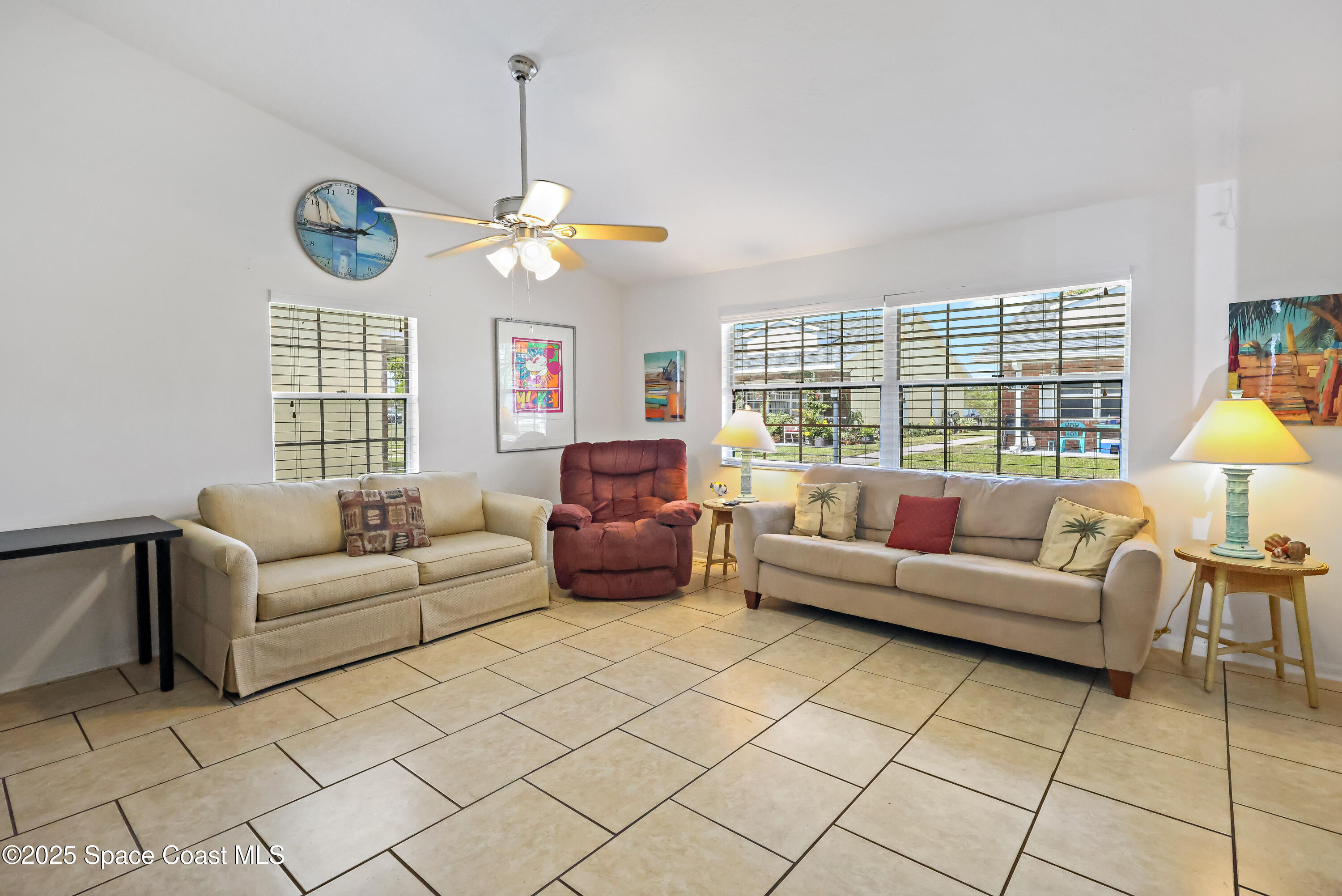 8520 U.S. Rte 1, Unit G3 Micco, FL 32976 - Photo 4 of 12 a living room with furniture a chandelier and a window