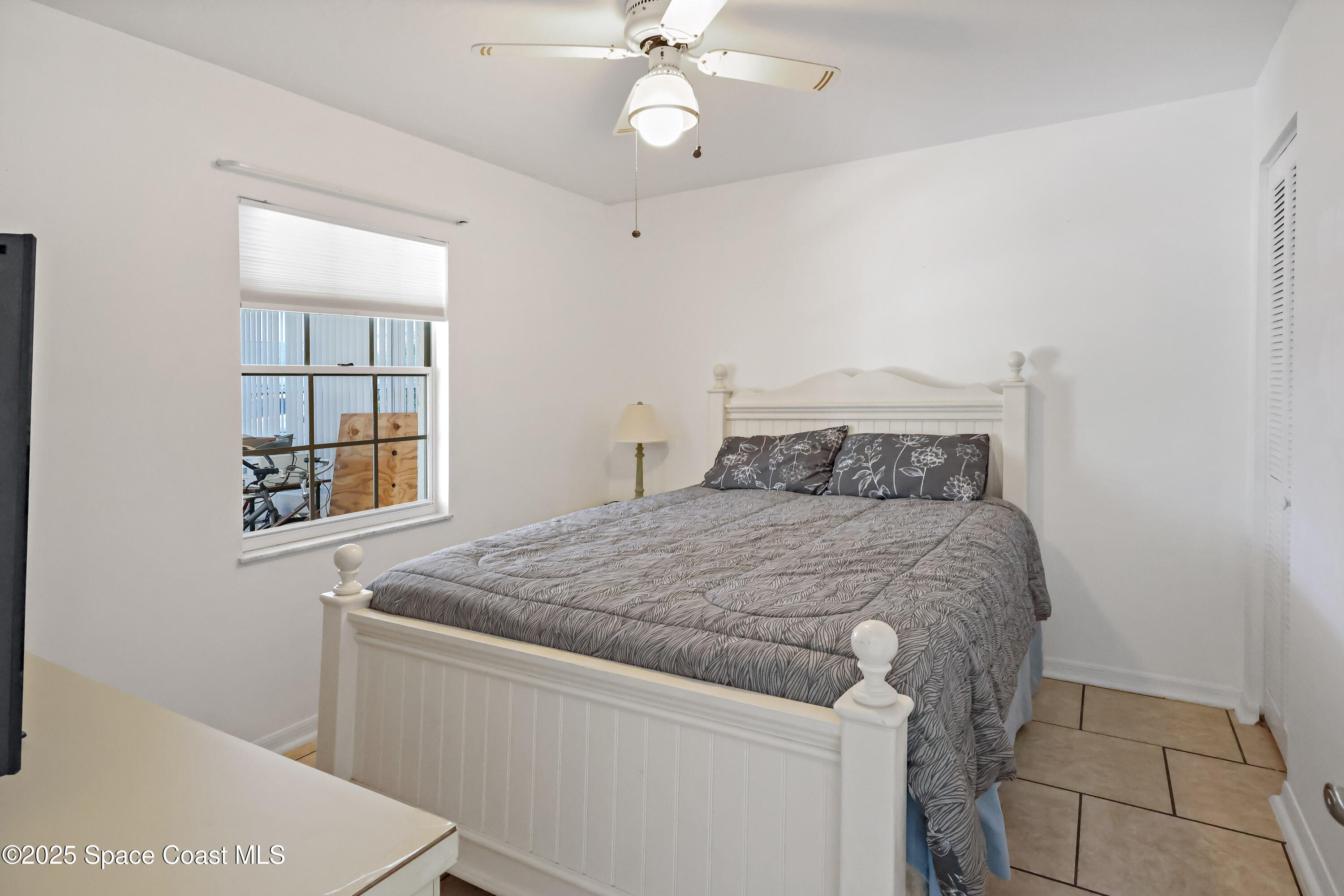 8520 U.S. Rte 1, Unit G3 Micco, FL 32976 - Photo 8 of 12 a bedroom with a bed and a window