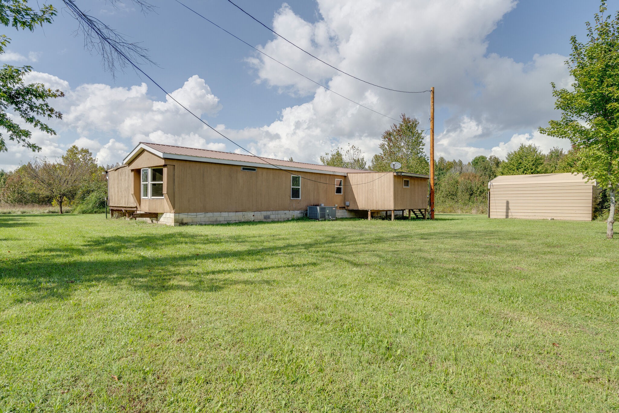 2031 Sugar Camp Road Springfield, TN 37172 - Photo 20 of 42 a view of a white house with a big yard and large trees