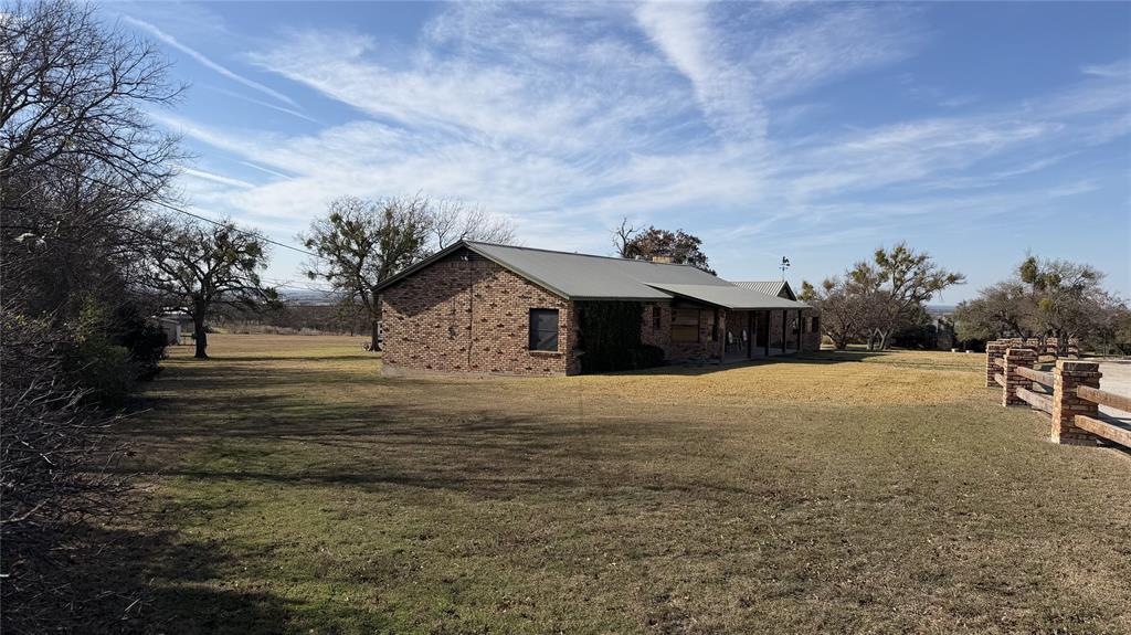 5 W Highway Goldthwaite, TX 76844 - Photo 2 of 29 a yellow house with trees in front of it