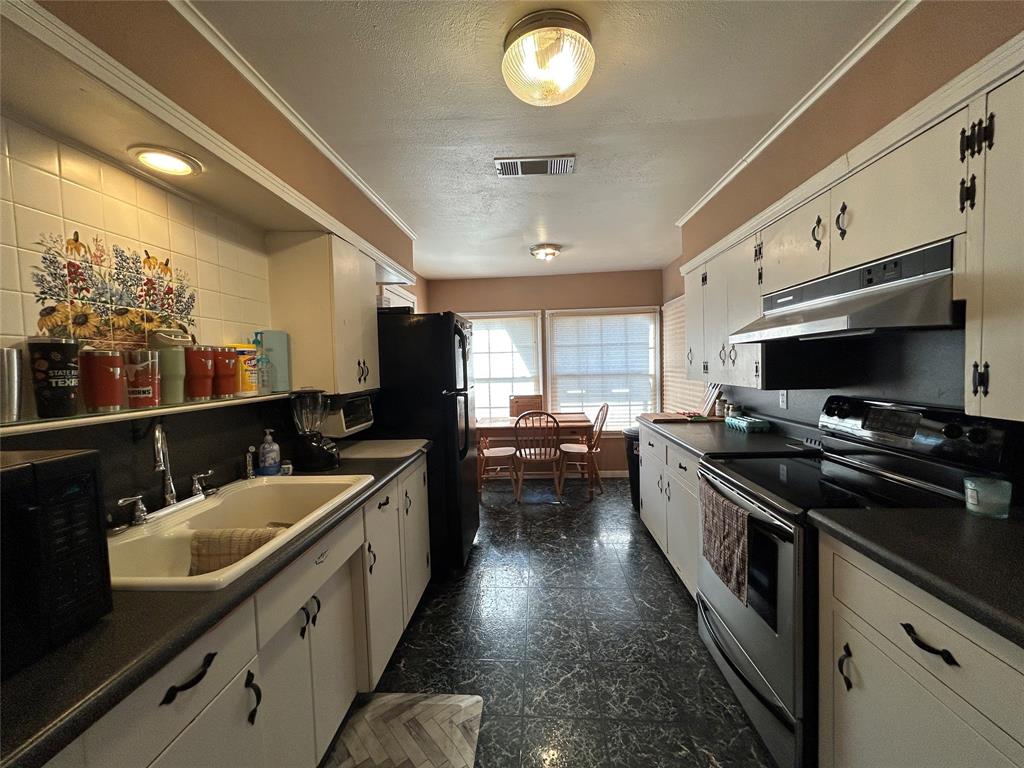 5 W Highway Goldthwaite, TX 76844 - Photo 21 of 29 a kitchen with stainless steel appliances a sink stove and refrigerator