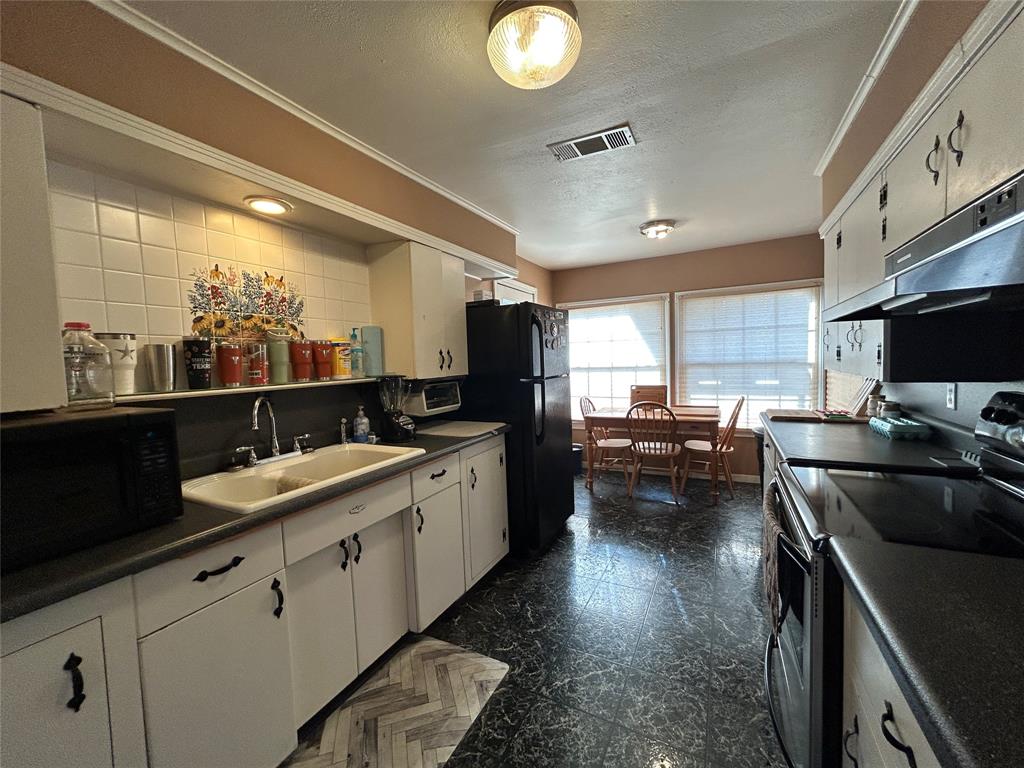 5 W Highway Goldthwaite, TX 76844 - Photo 22 of 29 a kitchen with a sink stove and cabinets
