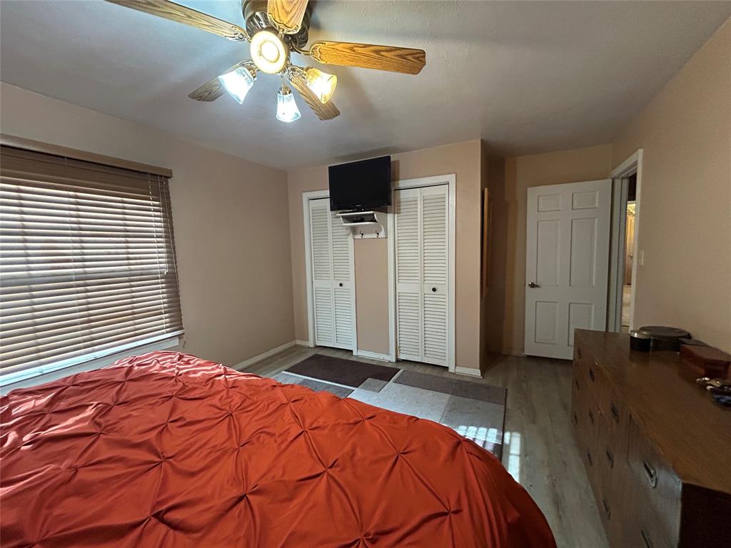 5 W Highway Goldthwaite, TX 76844 - Photo 24 of 29 a bedroom with a bed and a chandelier