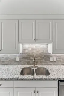 a kitchen with a sink and cabinets