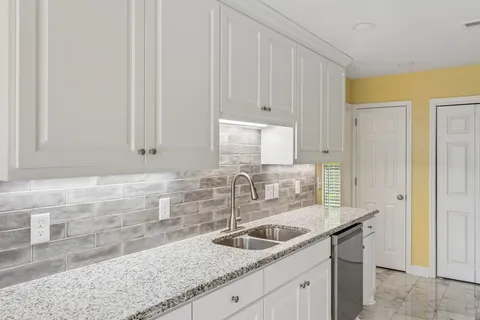 a kitchen with a stove and a refrigerator