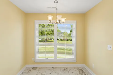 a bathroom with a bathtub and next to a window