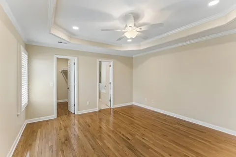 a view of an empty room with wooden floor