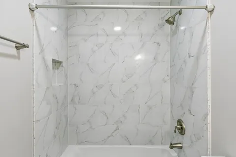 a front view of a house with a yard and potted plants