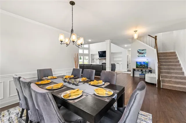 a view of a dining room with furniture wooden floor and chandelier