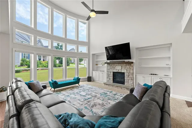 a living room with furniture a fireplace and a flat screen tv