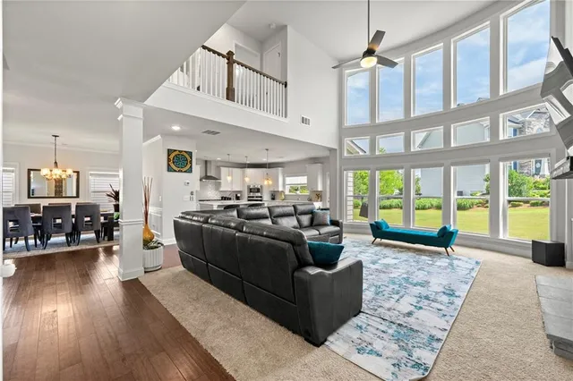 a living room with furniture and large windows