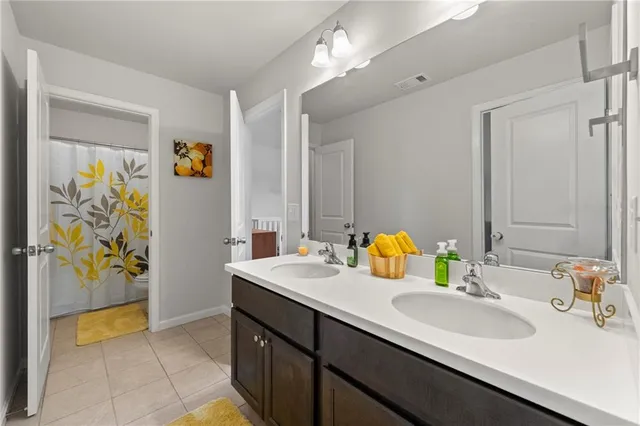 a bathroom with a sink double vanity and a mirror