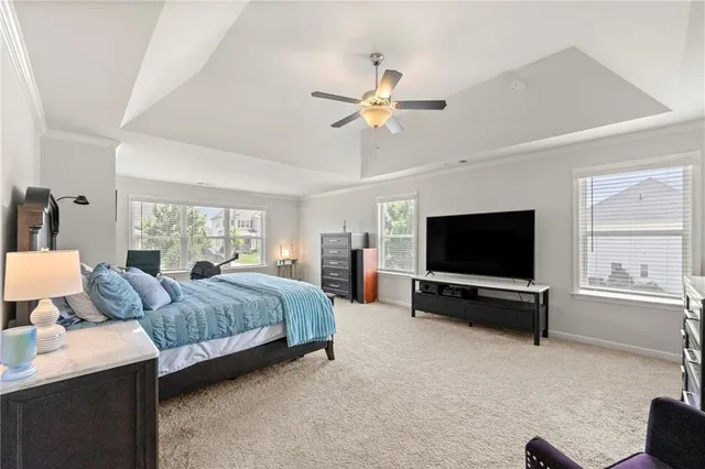 a living room with a bed and a flat screen tv
