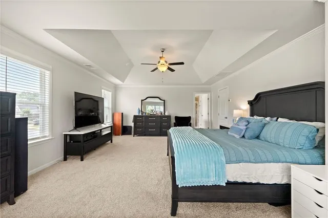 a bedroom with a bed and a flat screen television