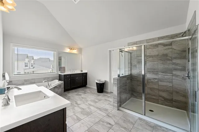 a bathroom with a sink mirror and a shower