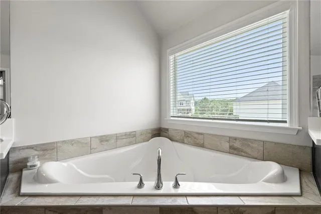 a bath tub sitting in a bathroom next to a window