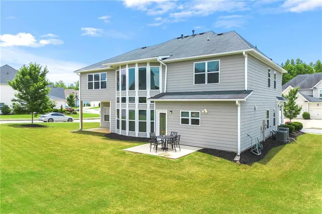 an aerial view of a house with outdoor space and lake view