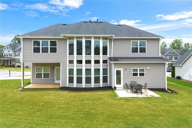 a view of a tennis ground with large trees